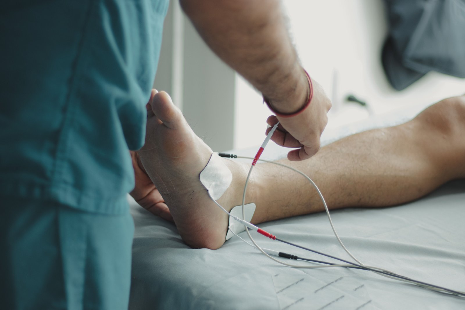 A podiatrist applying Swift microwave therapy to a patient’s foot